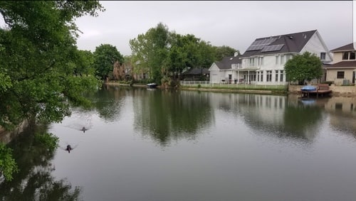 homes along Bayou St John near Demourelles Island in New Orleans showing residential waterfront landscape and calm canal