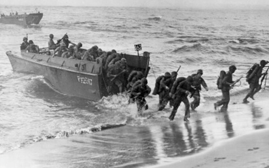 World War II Higgins boat landing craft unloading soldiers onto beach during amphibious assault in New Orleans designed LCVP vessel