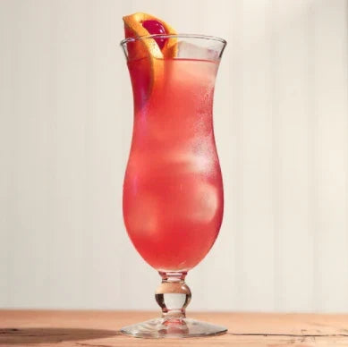 Hurricane cocktail in signature glass with orange garnish representing iconic New Orleans rum drink created at Pat O’Brien’s