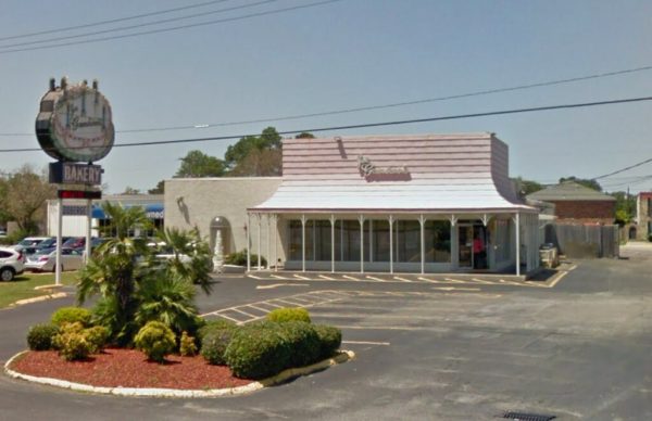 Gambino’s Bakery historic storefront building exterior with large front windows and residential-style upper floor